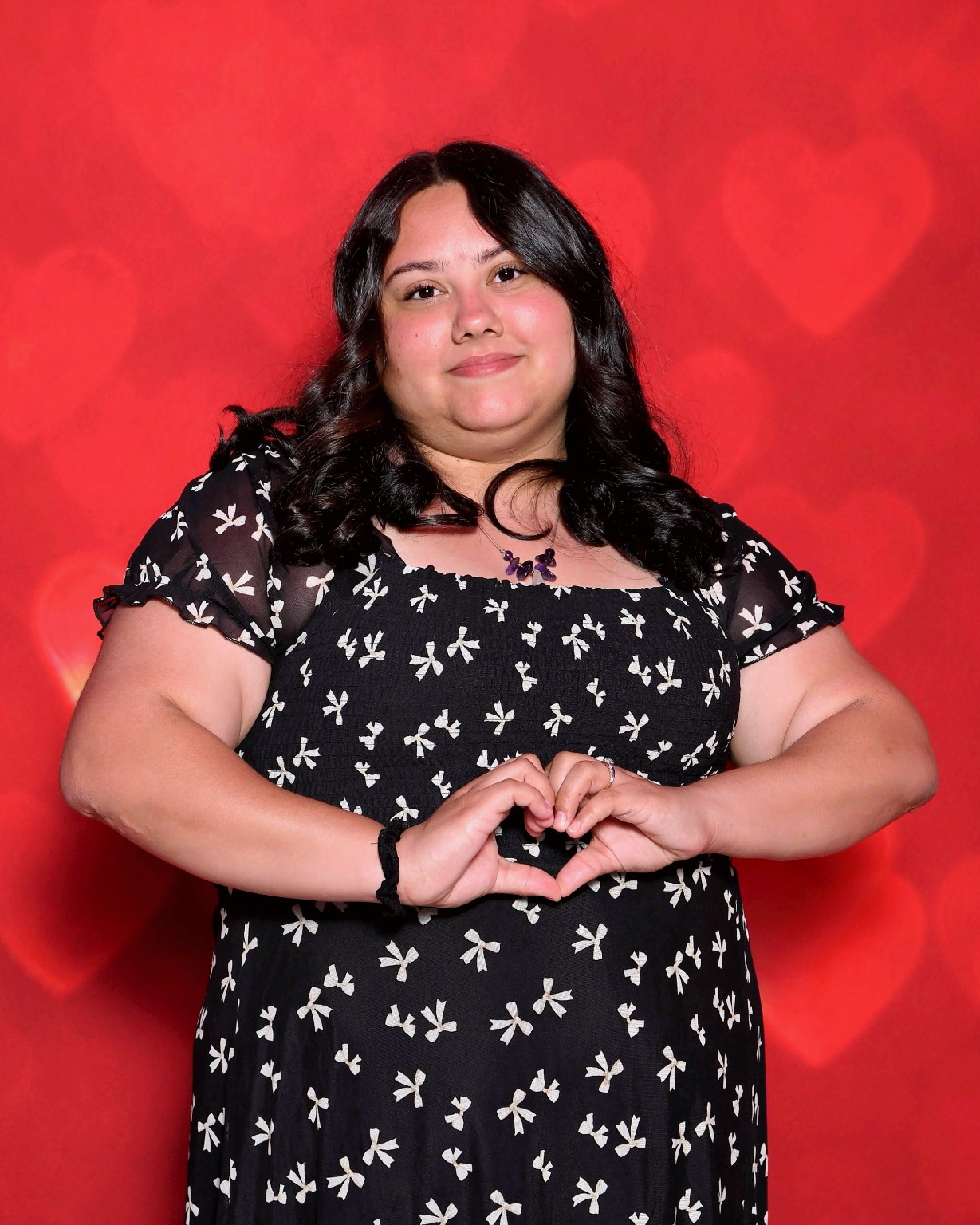 Alex, manager of The Caring Shelf, making a heart with her hands